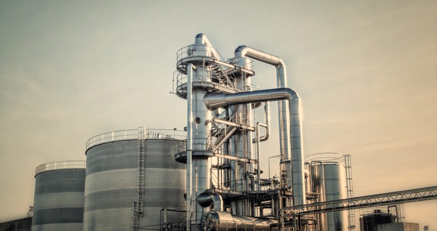 View of an industrial oil refinery with shiny tubes.